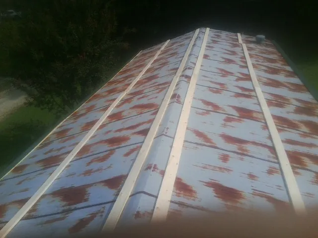 Rusted metal roof panels with new wood purlins before replacement — Storm Damage Roof Repair in Hardin by Roofing Brothers